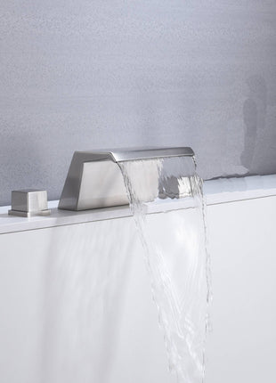 Brushed nickel waterfall tub faucet with hot and cold mixer.